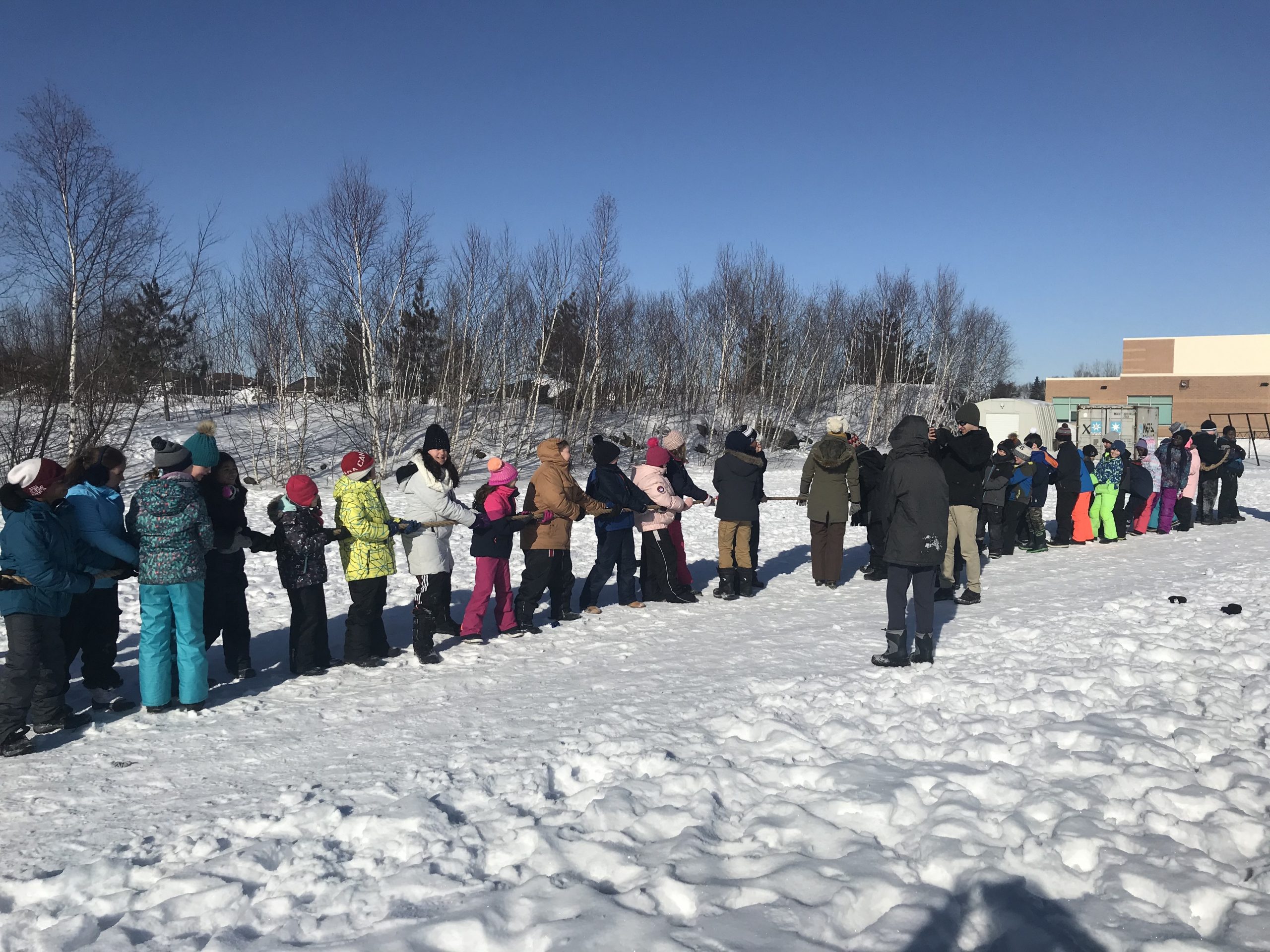 Students stand together in the snow